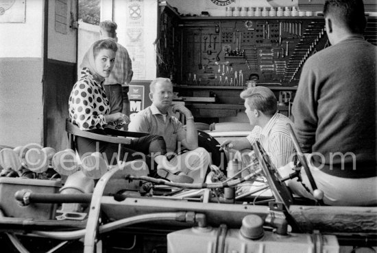 In a backstreet garage of Monte Carlo, Lance Reventlow (striped shirt), the driver-owner-constructor, helps to prepare his Scarab car for the race. On left his wife Jill St. John and chief mechanic and driver Chuck Daigh. Monaco Grand Prix 1960. - Photo by Edward Quinn