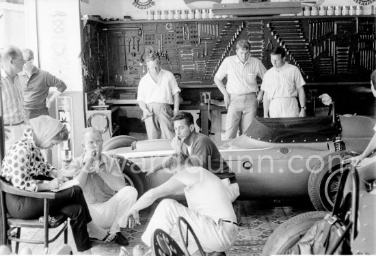 In a backstreet garage of Monte Carlo, Lance Reventlow, the driver-owner-constructor, helps to prepare his Scarab car for the race. On left his wife Jill St. John and chief mechanic and driver Chuck Daigh. Monaco Grand Prix 1960. - Photo by Edward Quinn