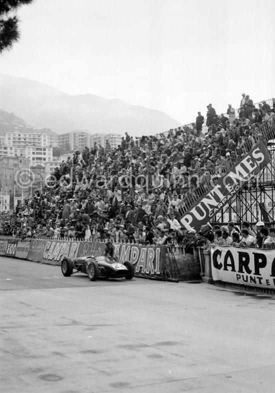 Innes Ireland pushes his N° 22 Lotus 18 uphill and right around the twisting Monaco circuit so that he can finish the race. His effort was repaid when he got 9th place and one point for the world championship. Monaco Grand Prix 1960. - Photo by Edward Quinn