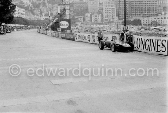 Innes Ireland pushes his N° 22 Lotus 18 uphill and right around the twisting Monaco circuit so that he can finish the race. His effort was repaid when he got 9th place and one point for the world championship. Monaco Grand Prix 1960. - Photo by Edward Quinn