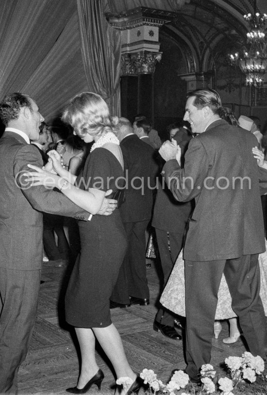 Stirling Moss, winner of the Grand Prix, dances with Swedish model Helga Mayerhoffer. Jack Brabham on the right. Gala of Monaco Grand Prix 1960. - Photo by Edward Quinn