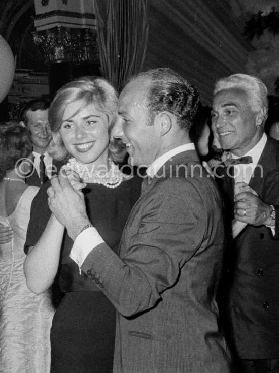 Stirling Moss, winner of the Grand Prix, gets into the party spirit as he dances with Swedish model Helga Mayerhoffer. Piero Taruffi on the right Gala of Monaco Grand Prix 1960. - Photo by Edward Quinn