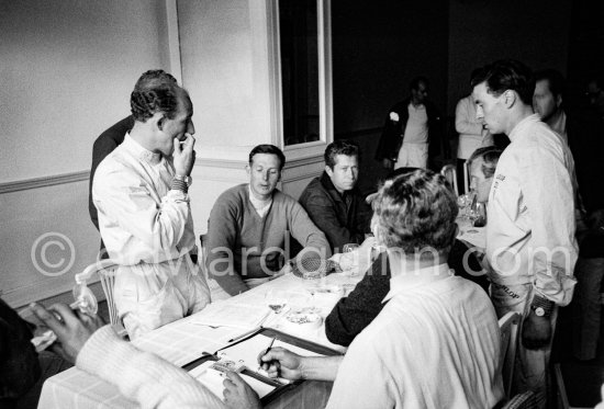 Stirling Moss as chairman addresses the inaugural meeting of a new racing drivers association (Grand Prix Drivers’ Association) in room 183 of Monte Carlo\'s hotel Metropole. Sitting on his left Henry Taylor and Olivier Gendebien, standing Jim Clark. Monaco Grand Prix 1961. - Photo by Edward Quinn