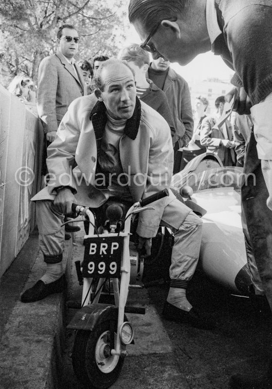 Stirling Moss enjoys riding around with his 1961 Trojan Trobike. Monaco Grand Prix 1961. - Photo by Edward Quinn