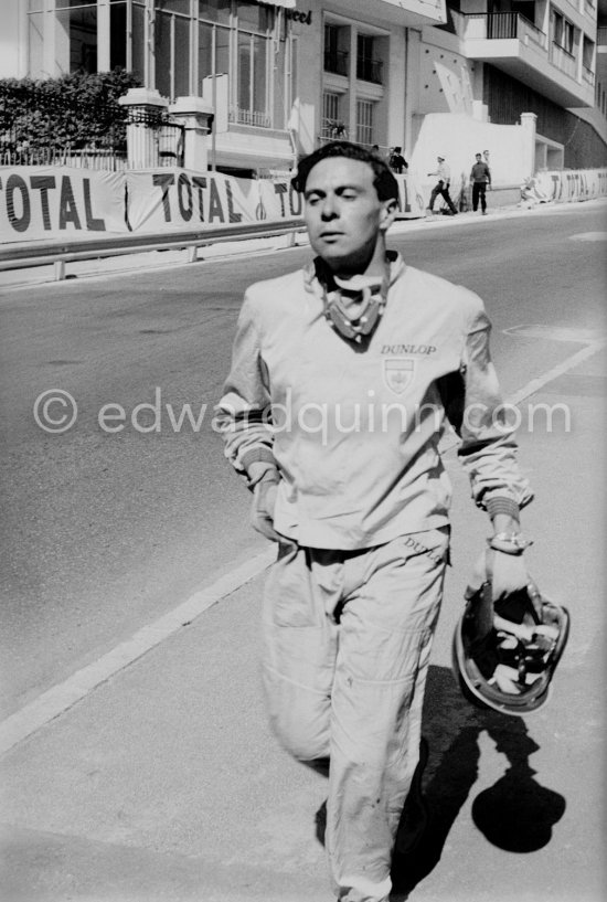 Practice saw Jim Clark crash his Lotus heavily at Ste Devote. He walks back to the pits. Monaco Grand Prix 1961. - Photo by Edward Quinn