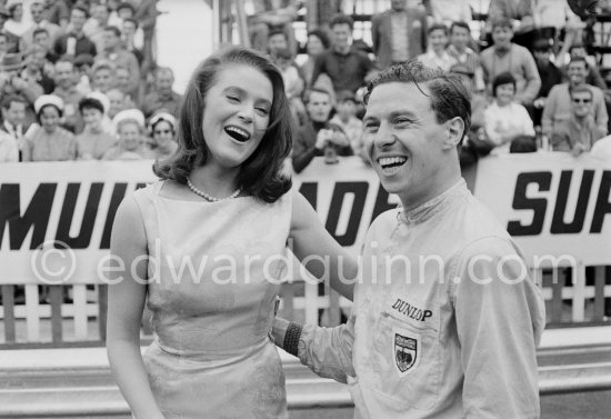 An American film company making the film "Love is a Ball" took advantage of the race to shoot some scenes during practice. Here French actress Béatrice Altariba is with the British driver Jim Clark. Monaco Grand Prix 1962. - Photo by Edward Quinn