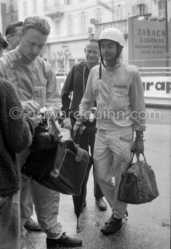 Dan Gurney (left) signing autographs, Phil Hill with umbrella. Monaco Grand Prix 1962. - Photo by Edward Quinn