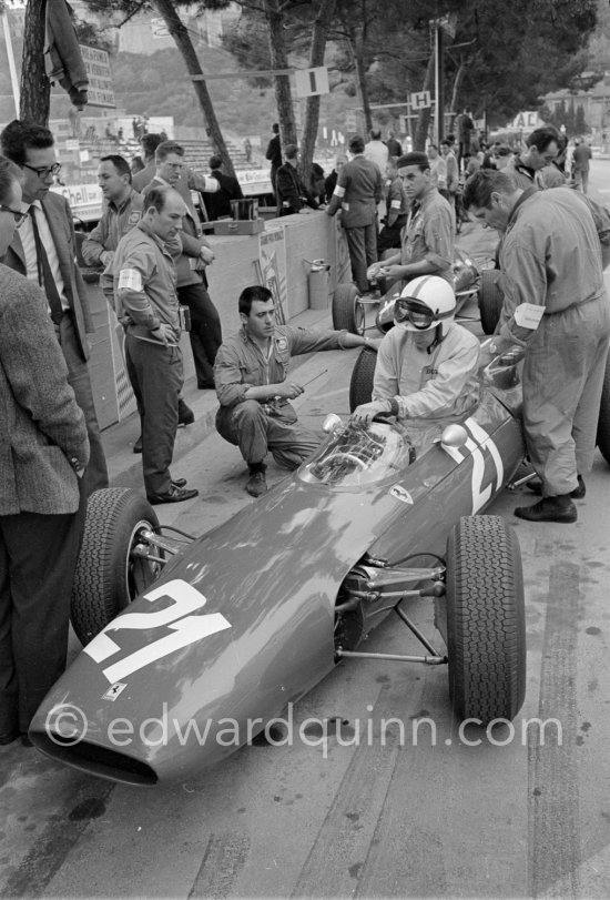 Stirling Moss (left) with John Surtees, (21) Ferrari 158. On the left Mauro Forghieri. Monaco Grand Prix 1964. - Photo by Edward Quinn