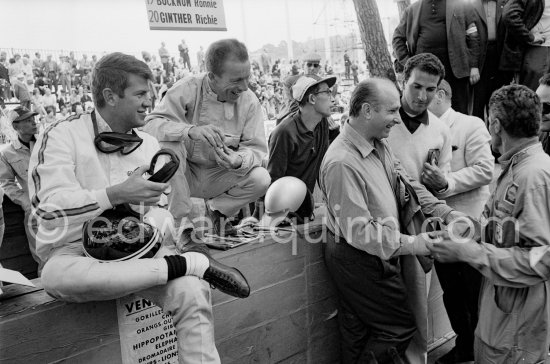 From left Ronnie Bucknum, Richie Ginther, and Juan Manuel Fangio. Monaco Grand Prix 1965. - Photo by Edward Quinn