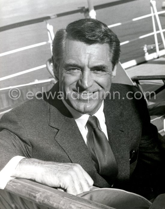 Cary Grant on board Onassis' yacht Christina. Monaco harbor 1957. - Photo by Edward Quinn