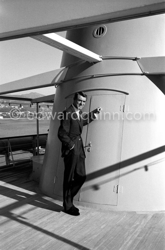 Cary Grant on board Onassis' yacht Christina. Monaco harbor 1957. - Photo by Edward Quinn