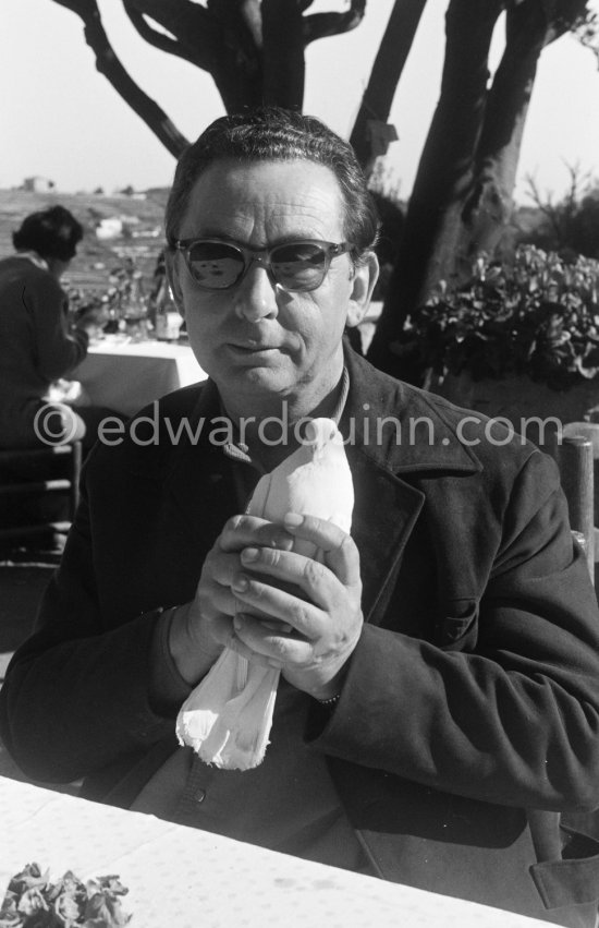 The painter Hans Hartung carefully holding a dove. At Restaurant Colombe d'Or, Saint-Paul-de-Vence 1961. - Photo by Edward Quinn