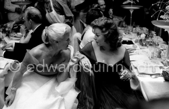 Susan Hayward and Ginger Rogers in animated conversation during the closing gala dinner at Cannes Film Festival 1956. - Photo by Edward Quinn