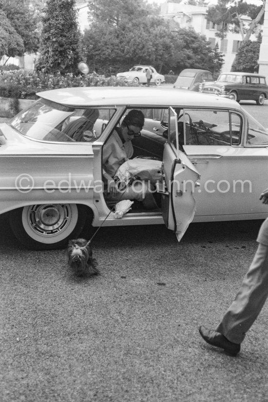 Audrey Hepburn and her little dog. Cap d\'Antibes, Eden Roc 1960. Car: 1960 Chevrolet Bel Air Sport Sedan - Photo by Edward Quinn