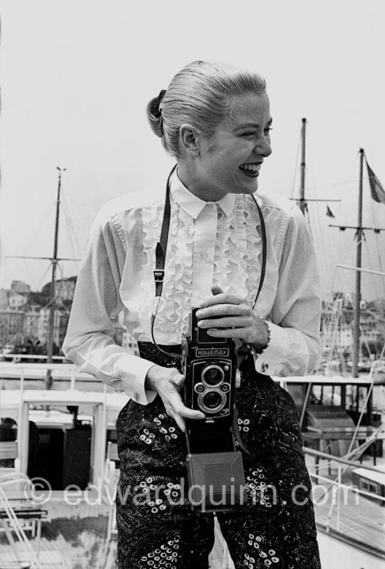 Grace Kelly with her Rolleiflex. Cannes Film Festival. Cannes harbor 1955. - Photo by Edward Quinn