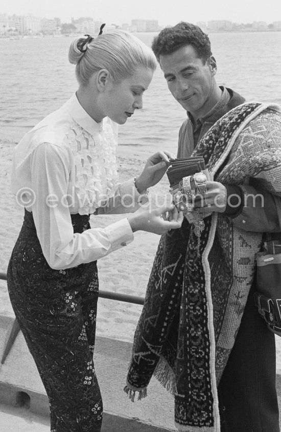 Grace Kelly and a street vendor. Cannes Film Festival 1955. - Photo by Edward Quinn