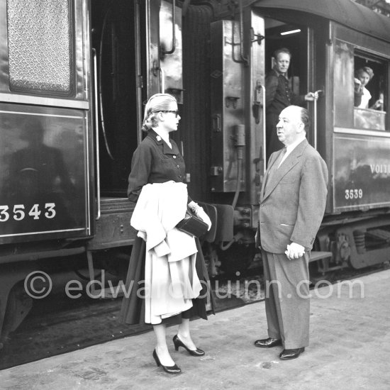 Grace Kelly arriving at the Cannes Railway Station, met by Alfred Hitchcock. It was the third time she was in Europe. In 1947 she came with the family, in 1949 on assignement, she was then a fashion model. Cannes 1954. - Photo by Edward Quinn