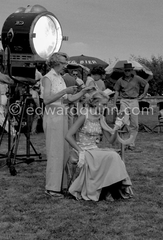 Grace Kelly being prepared by the dresser for a scene in the film "To Catch a Thief". On the right Alfred Hitchcock. Cannes 1954. - Photo by Edward Quinn