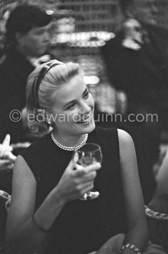 Grace Kelly during a press cocktail party at the Carlton Hotel, where she charmed everybody by trying out her French and emphasizing her words with gestures and expressions. Cannes 1954. - Photo by Edward Quinn