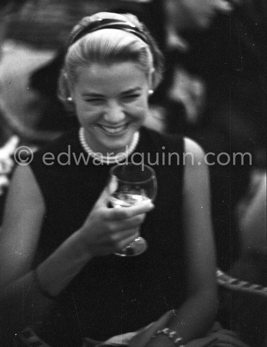 Grace Kelly during a press cocktail party at the Carlton Hotel, where she charmed everybody by trying out her French and emphasizing her words with gestures and expressions. Cannes 1954. - Photo by Edward Quinn