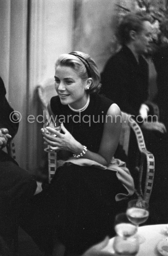 Grace Kelly during a press cocktail party at the Carlton Hotel, where she charmed everybody by trying out her French and emphasizing her words with gestures and expressions. Cannes 1954. - Photo by Edward Quinn