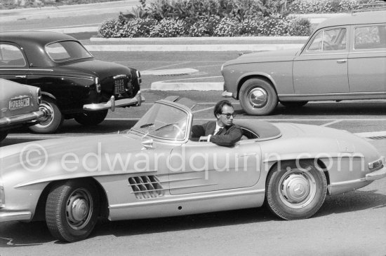 Prince Karim Khan. Cannes 1958. Car: 1957-63 Mercedes-Benz 300 SL Roadster. In the background two Peugeot 403 - Photo by Edward Quinn