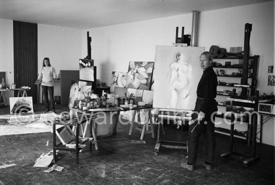 Louis le Brocquy and his wife Anne Madden le Brocquy at their studio with painting "Laussel Venus" by le Brocquy and under the easel "Land near Kilnaboy" by Madden. Carros 1964. - Photo by Edward Quinn