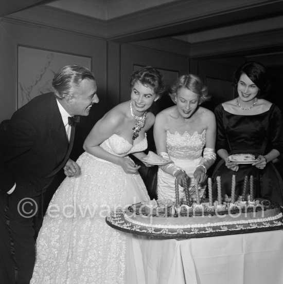 Self service at the Cannes Film Festival Vittorio de Sica, Sophia Loren, Mrs. de Sica, Silvana Mangano (left to right). Loren is wearing an evening gown designed by Emilio Schuberth, Cannes Film Festival, 27 April 1955. - Photo by Edward Quinn