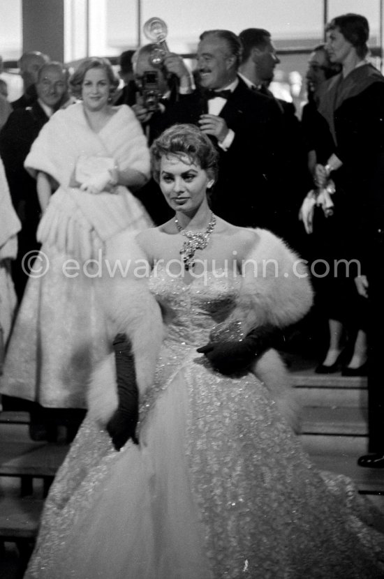 Sophia Loren, wearing an evening gown designed by Emilio Schuberth, making her entry to the Palais du Festival Cannes 27 April 1955. - Photo by Edward Quinn