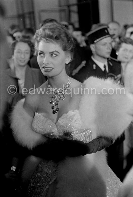 Sophia Loren, wearing an evening gown designed by Emilio Schuberth, making her entry to the Palais du Festival Cannes 27 April 1955. - Photo by Edward Quinn