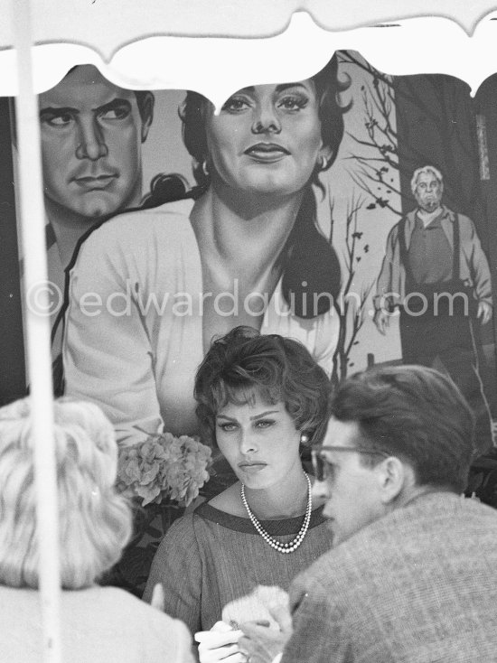 Sophia Loren in front of the film poster of "Desire Under the Elms" ("Desir sous les Ormes"), starring Sophia Loren and Anthony Perkins. Cannes Film Festival 1958. - Photo by Edward Quinn