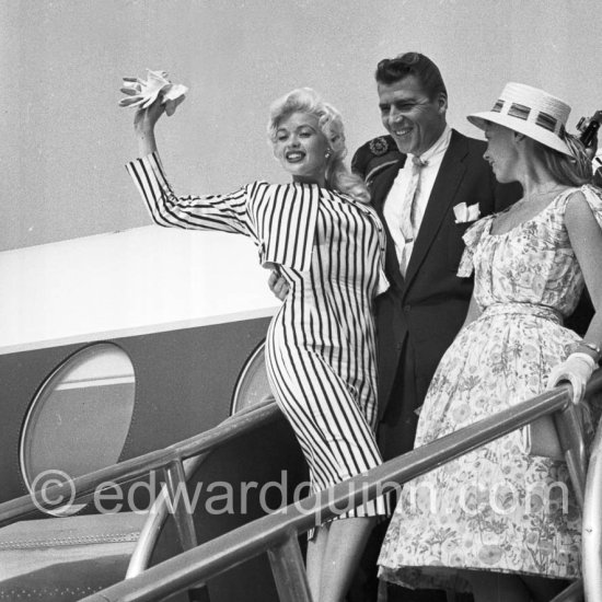 When Jayne Mansfield came to the Cannes Film Festival in 1958, she had just married Mickey Hargitay, the ex-muscle man in Mae West’s nightclub act and former Mr. Universe. From the moment of her arrival at Nice Airport, Jayne had to fight her way through a crowd of fans and journalists. Nice Airport 1958. - Photo by Edward Quinn