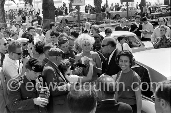 Jane Mansfield, signing autographs, on a return trip to the Cannes Film Festival 1964. - Photo by Edward Quinn