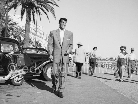 Dean Martin came to the Riviera after having entertained troops in France. Very elegantly dressed, remarked the locals, he walks along the Carlton beach. Cannes 1953. Car: Citroën Traction Avant 11BL Légère - Photo by Edward Quinn