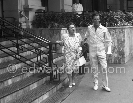 Gossip columnist Elsa Maxwell and General Franco\'s son-in-law Marquis De Villaverde in front of Hotel de Paris. Monte Carlo 1960. - Photo by Edward Quinn