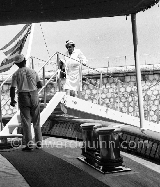 American gossip columnist Elsa Maxwell getting on board Onassis\' yacht Christina. Monaco harbor 1956. - Photo by Edward Quinn