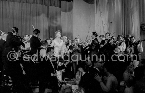 Elfie Mayerhofer flew specially from Vienna Opera House to sing Viennese waltz melodies during the gala. "Bal de la Rose" gala dinner at the International Sporting Club in Monte Carlo, 1956. - Photo by Edward Quinn