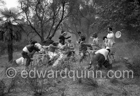 Paul Meurisse (white suit) during filming of “Le Déjeuner sur l'herbe” at the Auguste Renoir house "Les Collettes". With the aid of mechanical wind devices a tempest, the mistral, turns the déjeuner into catastrophe. Cagnes-sur-Mer 1959. - Photo by Edward Quinn