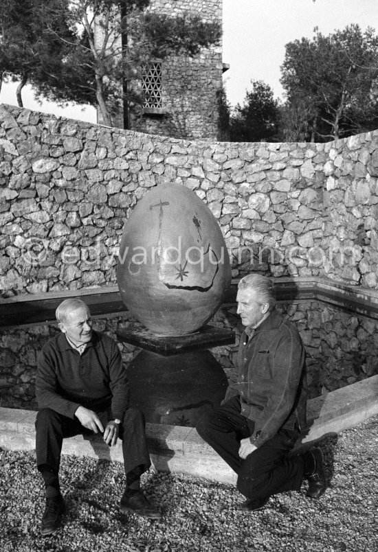 Juan Miró and Aimé Maeght in the gardens of Musée Maeght in front of a small pool with an "Oeuf cosmique" by Miró in center. Saint-Paul-de-Vence 1964. - Photo by Edward Quinn