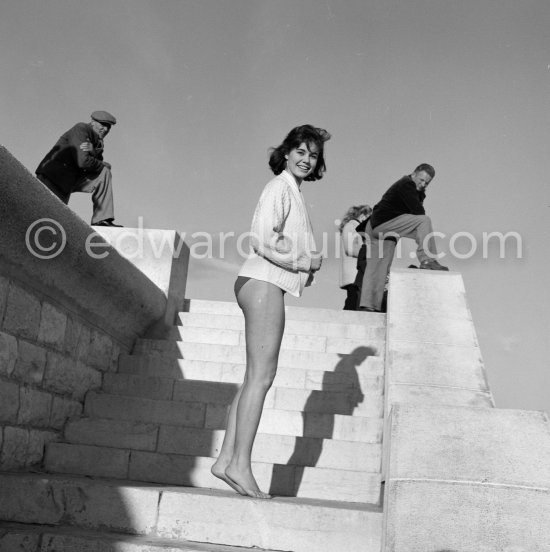 Giorgia Moll, German Italian fashion model, starlet and "Miss Rome" who was said to be the girl Joe DiMaggio had a romantic eye on to replace Marilyn Monroe. Giorgia, well guarded at the beach. Nice 1955. - Photo by Edward Quinn