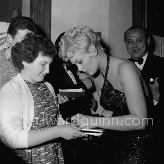 Kim Novak signing autographs at a gala evening, Cannes Film Festival 1956. - Photo by Edward Quinn