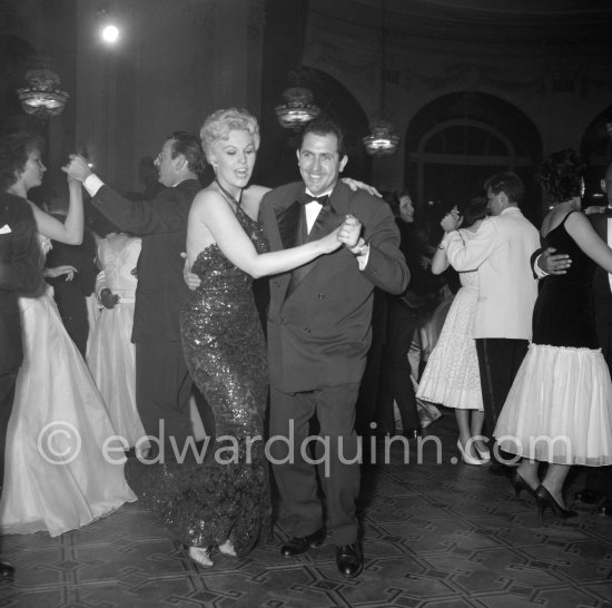 Kim Novak dancing with a local press photographer. Gala evening, Cannes Film Festival 1956. - Photo by Edward Quinn