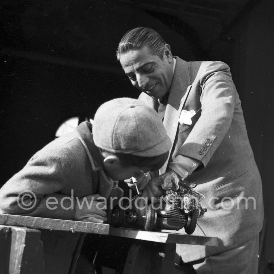 Aristotle Onassis with his son Alexander at Château de la Croë. He seems to be preparing his son\'s toy car. Cap d’Antibes 1954. - Photo by Edward Quinn