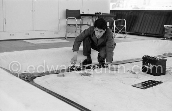 Alexander Onassis playing with his slot cars in the pool on board Onassis\' yacht Christina. Monaco harbor 1957. - Photo by Edward Quinn