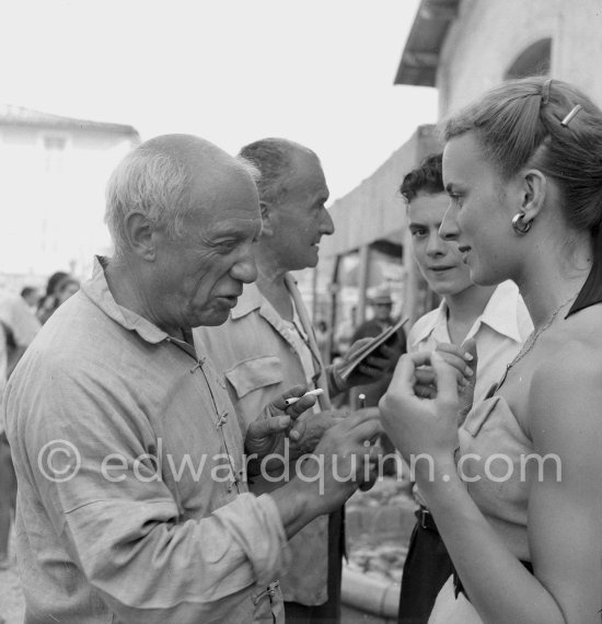 Pablo Picasso signing autographs on the occasion of the summer ceramics exhibition "Japon. Céramique contemporaine" at the Nérolium. Vallauris 21.7.1951. - Photo by Edward Quinn