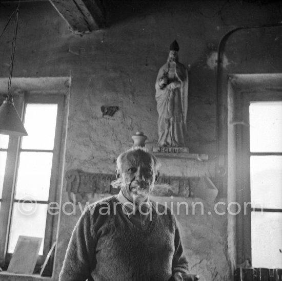 Pablo Picasso at the Madoura pottery in Vallauris. Above him is a statue of St-Claude, the patron saint of the potters, whose name was given to his younger son. Vallauris 23.3.1953. - Photo by Edward Quinn