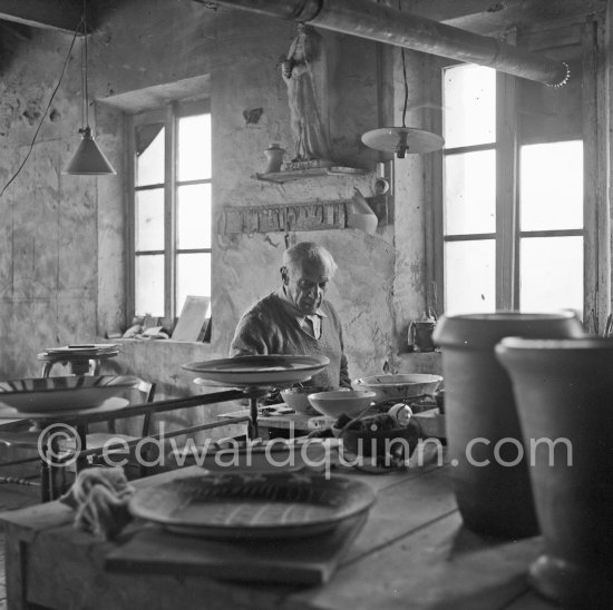 Pablo Picasso at work at the Madoura pottery in Vallauris. Above him is a statue of St-Claude, the patron saint of the potters, whose name was given to Pablo Picasso's younger son. Vallauris 23.3.1953. - Photo by Edward Quinn