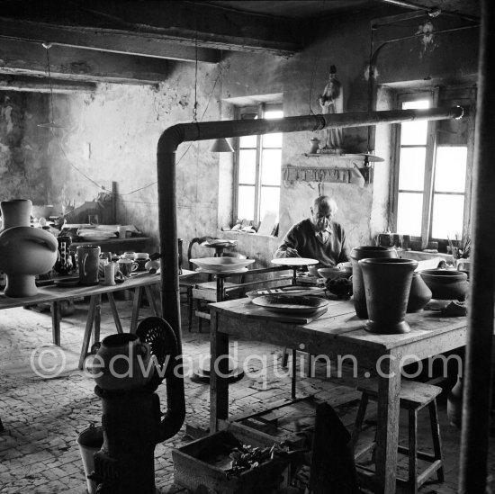Pablo Picasso at work at the Madoura pottery in Vallauris. Above him is a statue of St-Claude, the patron saint of the potters, whose name was given to his younger son. Vallauris 23.3.1953. - Photo by Edward Quinn