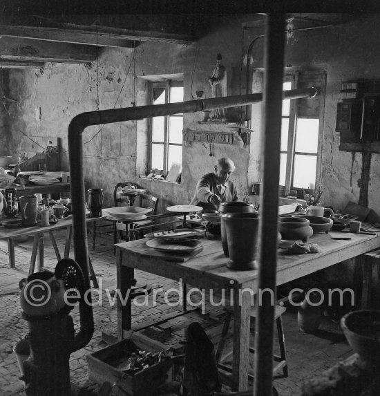 Pablo Picasso at work at the Madoura pottery in Vallauris. Above him is a statue of Saint-Claude, the patron saint of the potters, whose name was given to his younger son. Vallauris 23.3.1953. - Photo by Edward Quinn