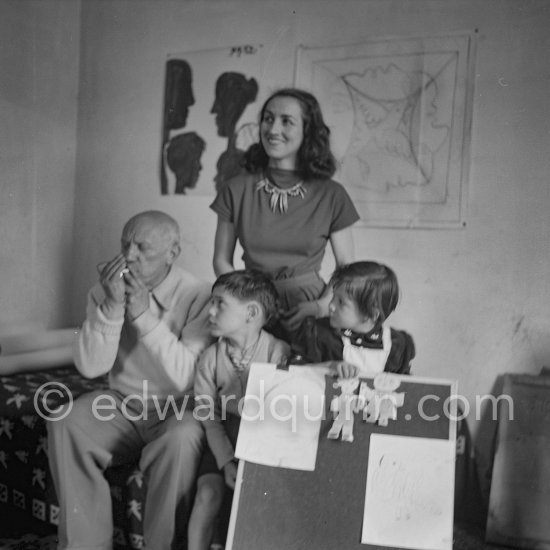 Encouraged by his father, Claude tries to do a portrait of Picasso, portraying him with a round face, deep furrows on his forehead. a triangle for a nose, and streaks of hair on the sides of his head. La Galloise, Vallauris 16 Apr 1953. - Photo by Edward Quinn